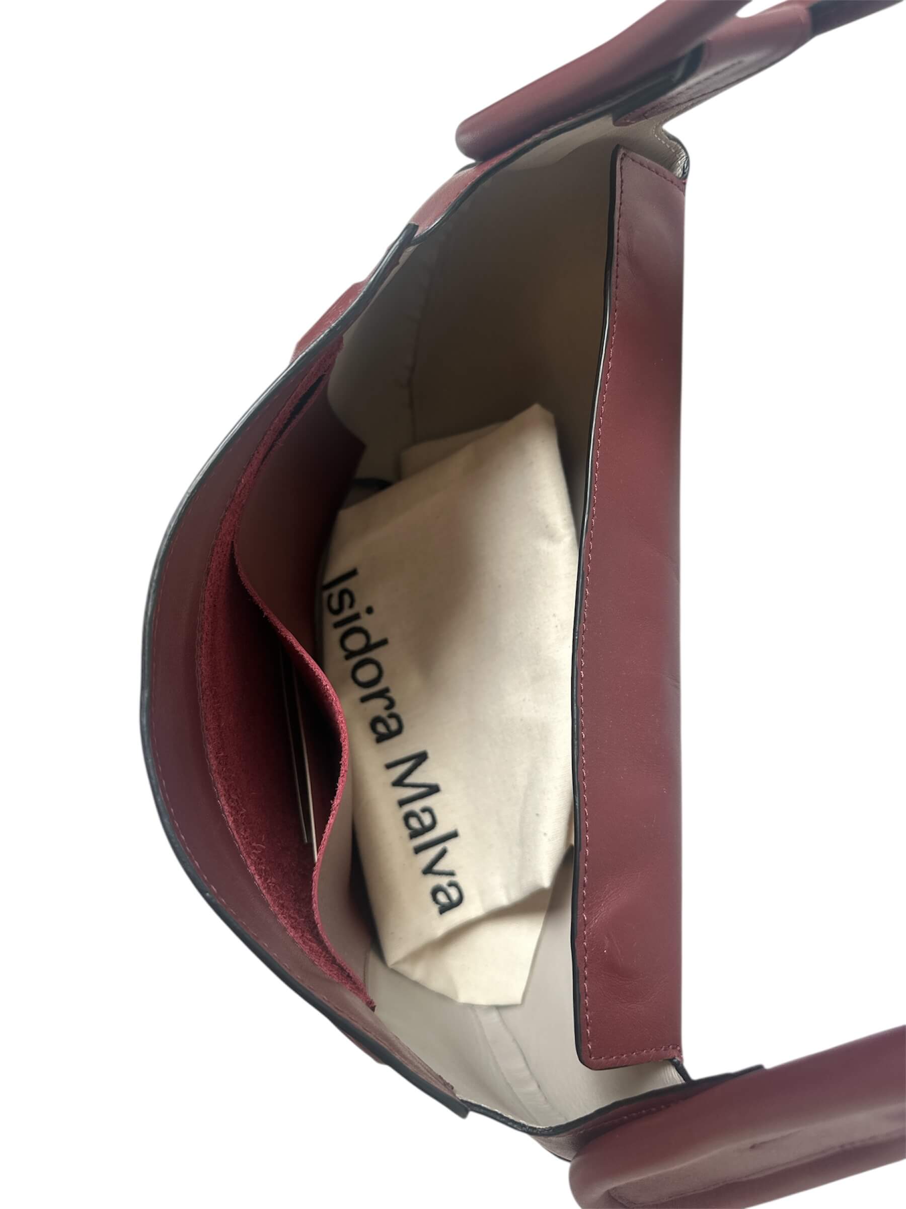 Close-up of a red handbag with 'Isidora Malva' branding on a white background.