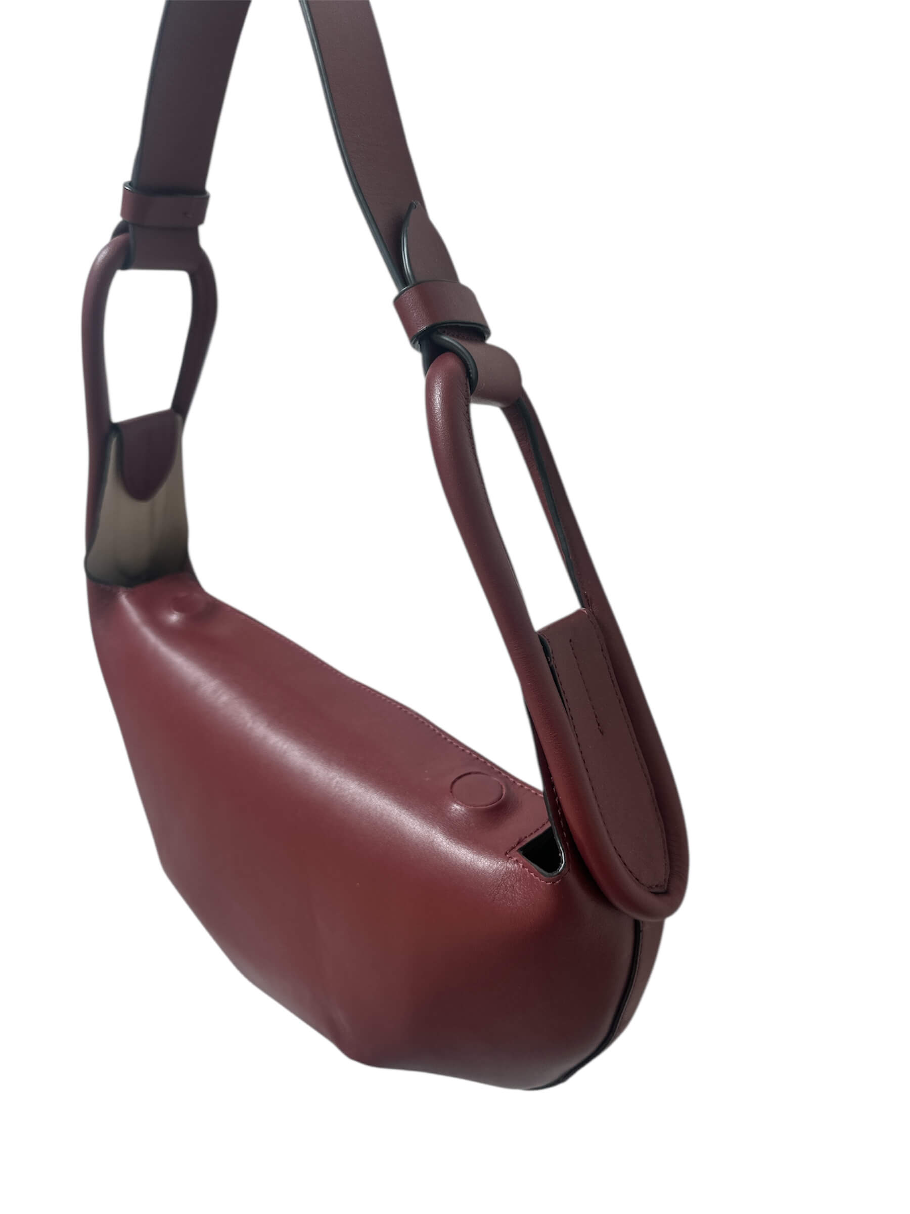 Maroon handbag with a strap on a white background.