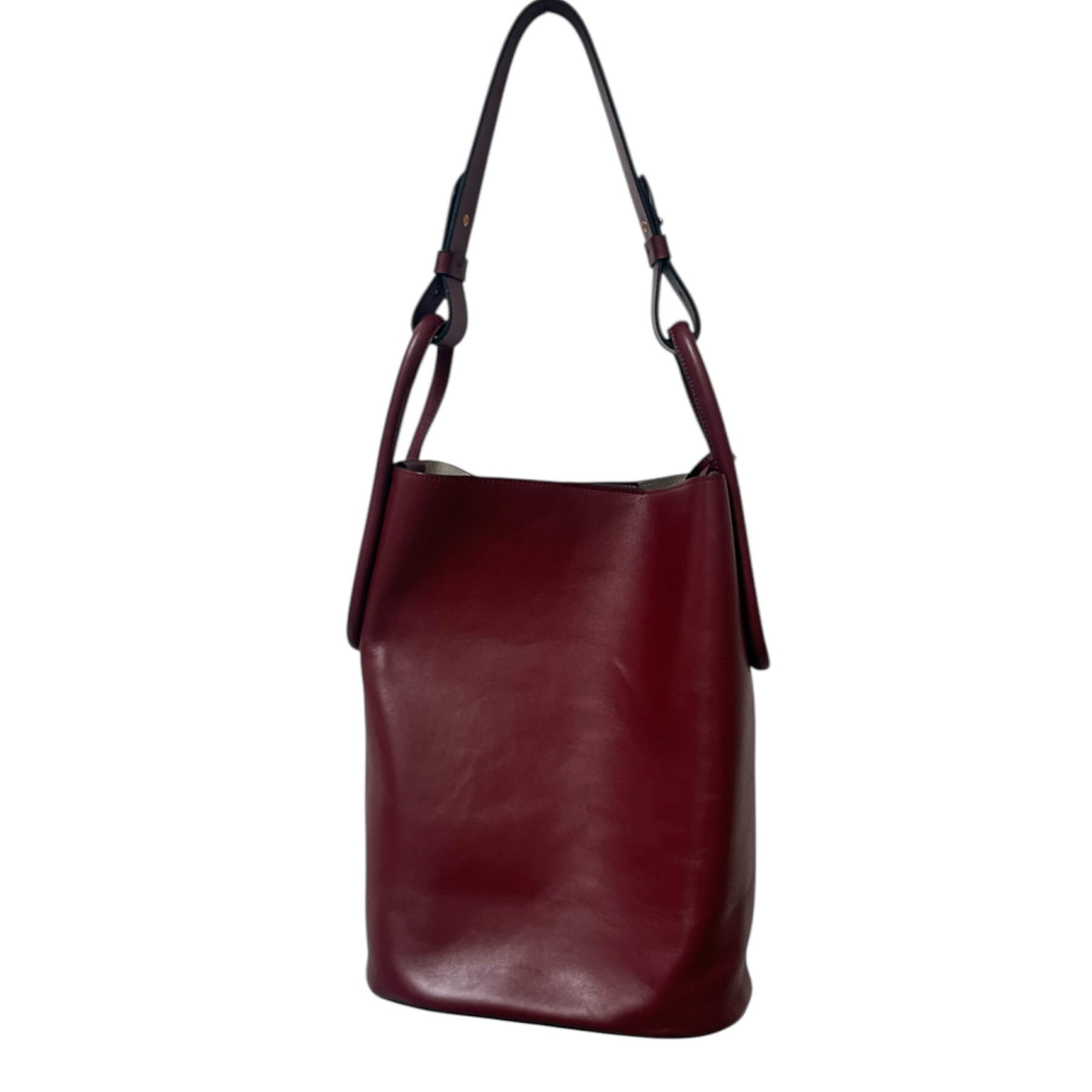Maroon leather handbag on a white background.