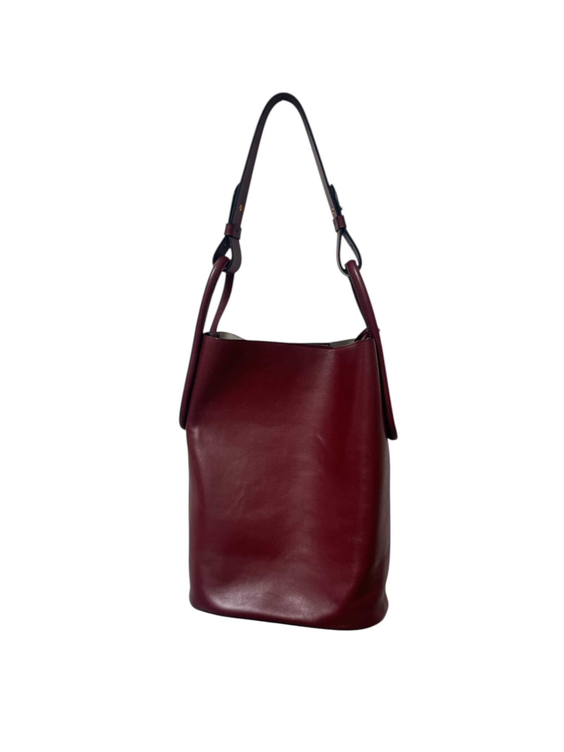 Maroon leather handbag on a white background.