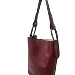 Brown leather handbag on a white background.