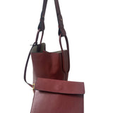Red leather handbag with a matching pouch on a white background.