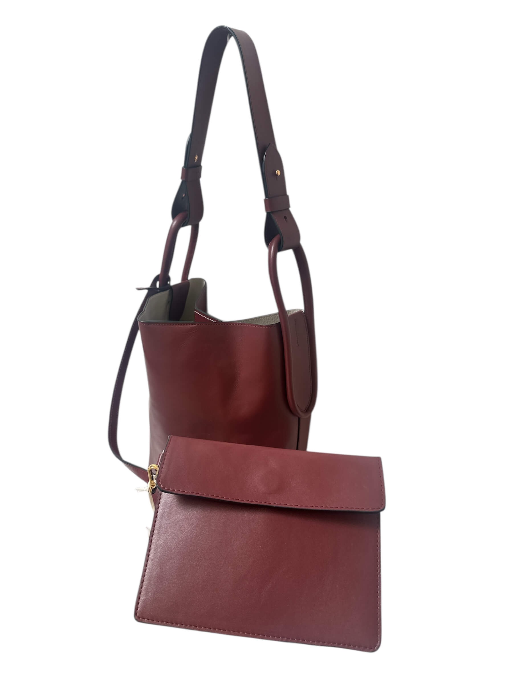 Red leather handbag with a matching pouch on a white background.