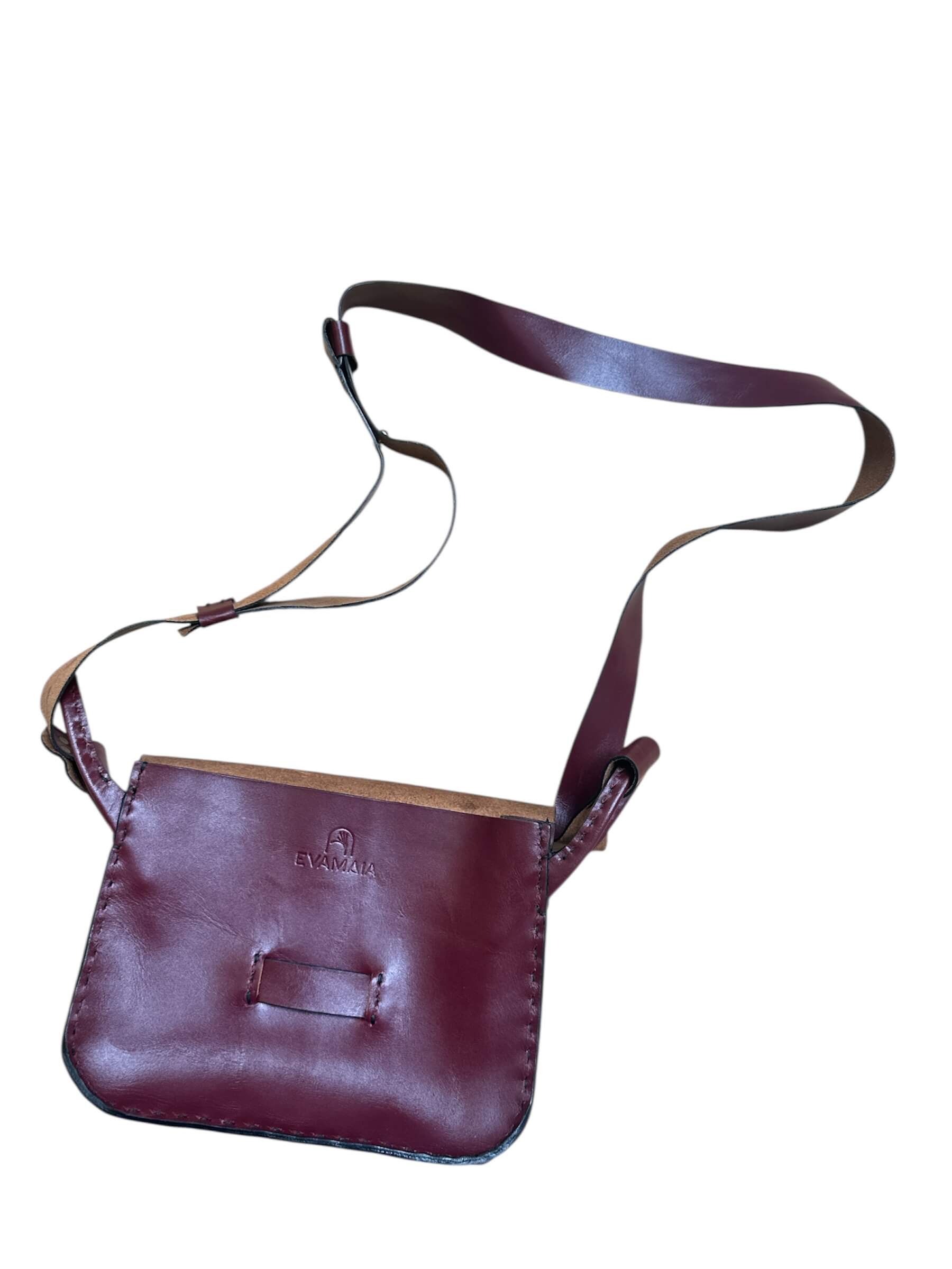 Red leather crossbody bag on a white background.