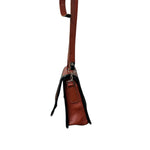 Brown leather carriel bag with a strap on a white background.