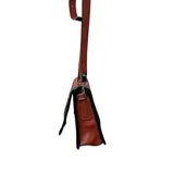 Brown leather carriel bag with a strap on a white background.