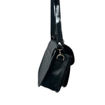 Black carriel crossbody purse with a strap on a white background.