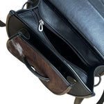 Close-up of a leather crossbody purse.