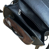 Close-up of a leather crossbody purse.