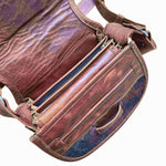 Brown leather bag with visible stitching and texture on a white background.