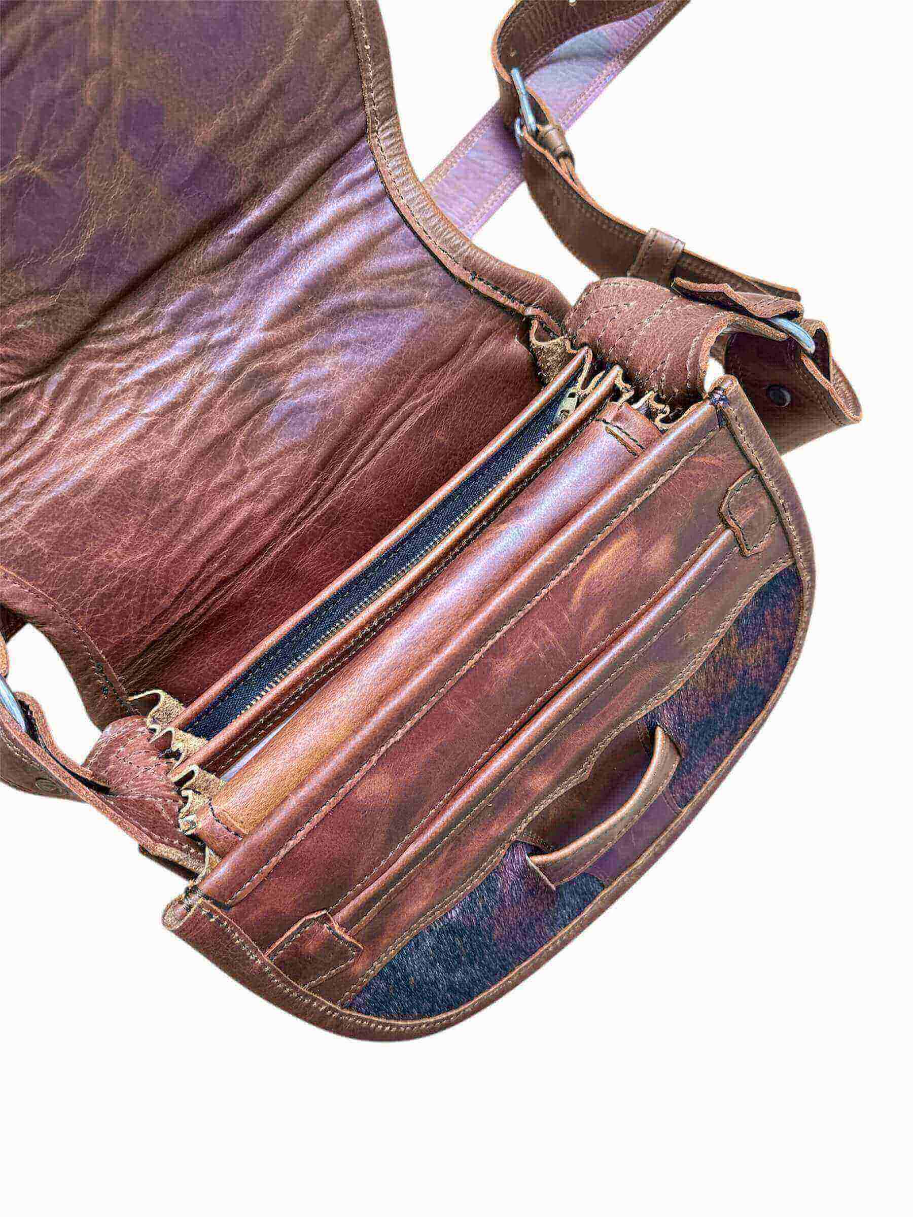 Brown leather bag with visible stitching and texture on a white background.
