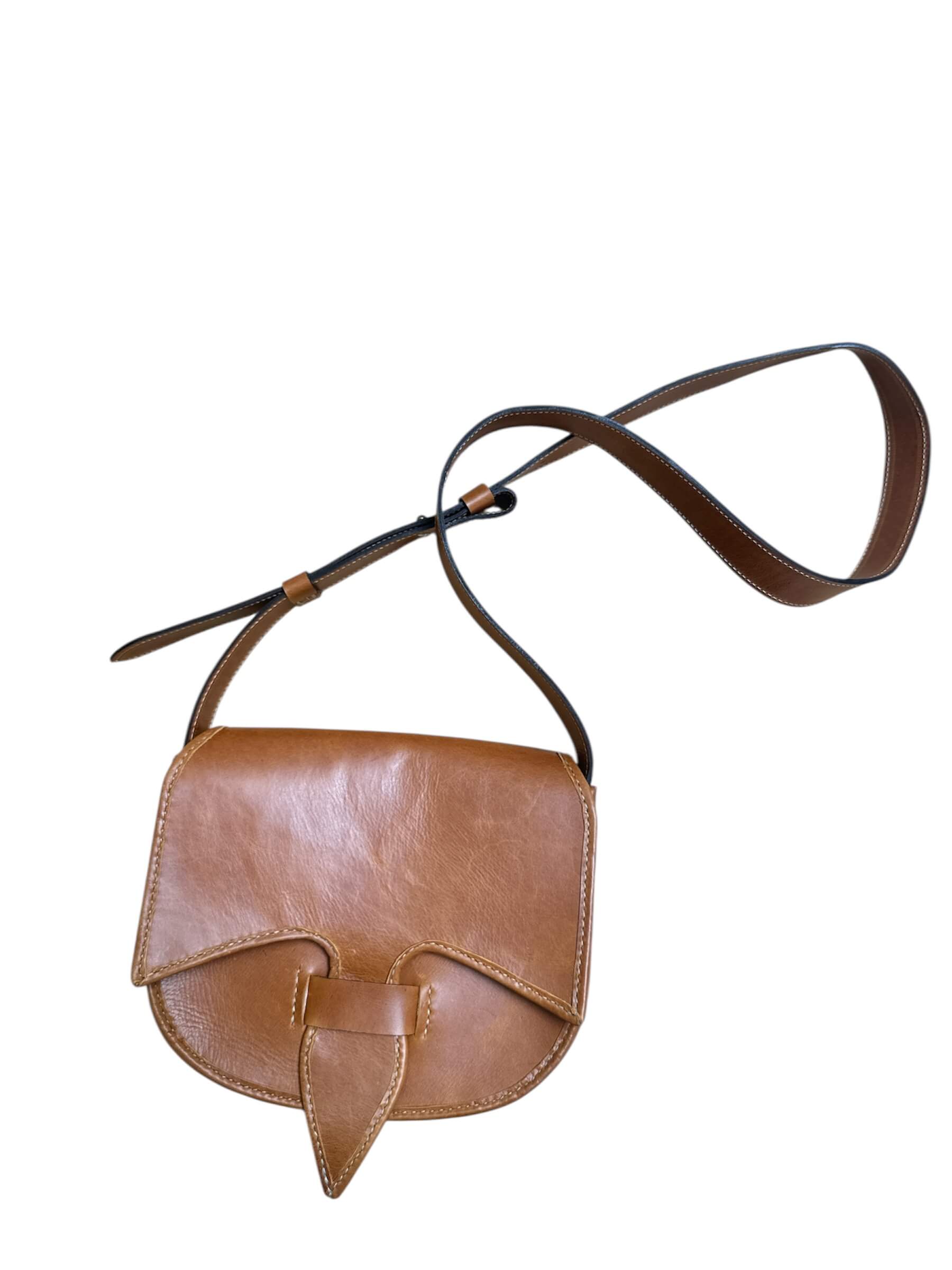 Close-up of a brown leather bag with visible stitching on a white background.