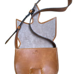 Close-up of a brown leather bag with visible stitching on a white background.