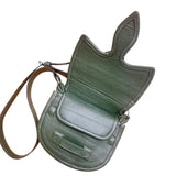 Green leather saddle bag with a strap on a white background. 