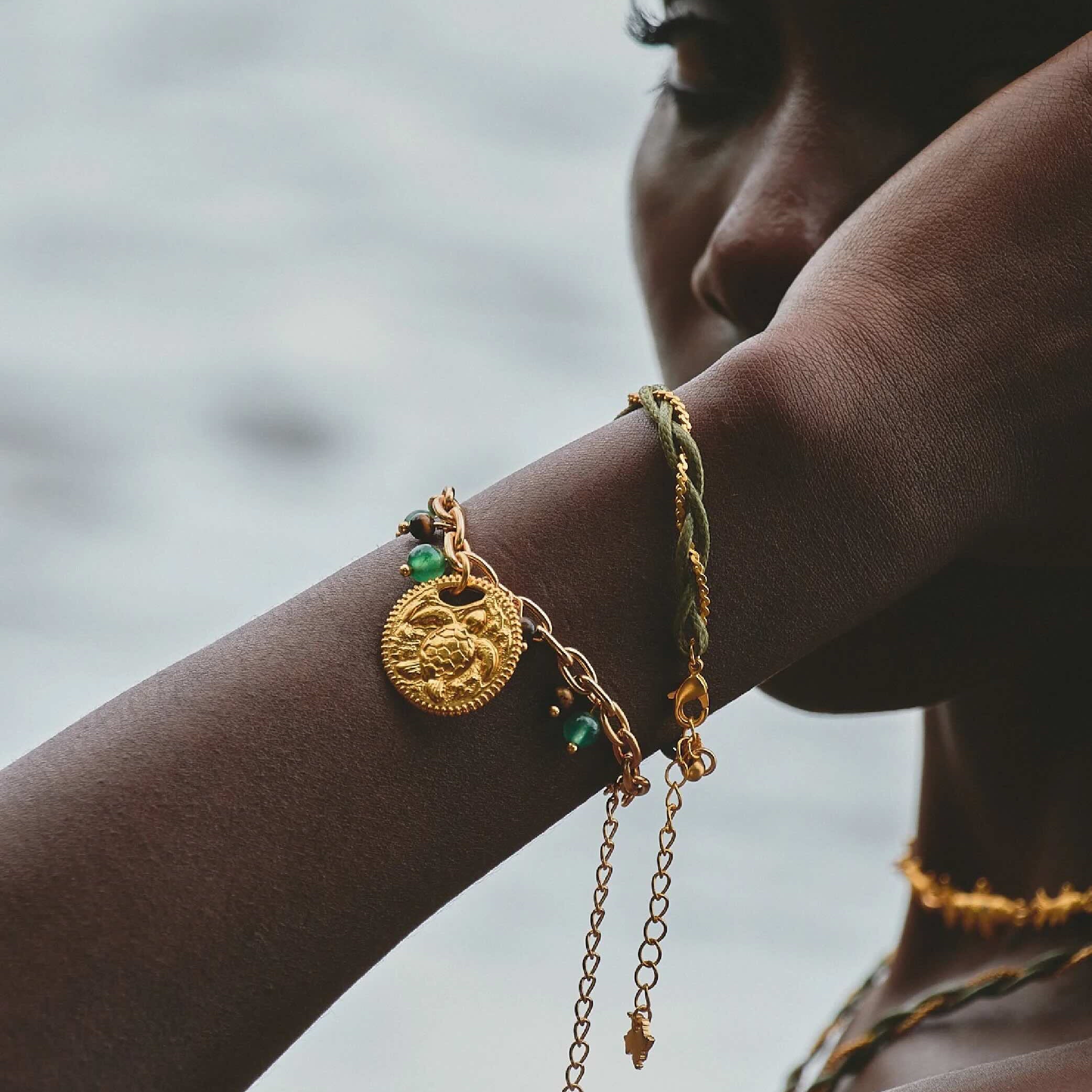 Woman wearing Refugio de Sol bracelet set with fossil jade and cat's eye stones.