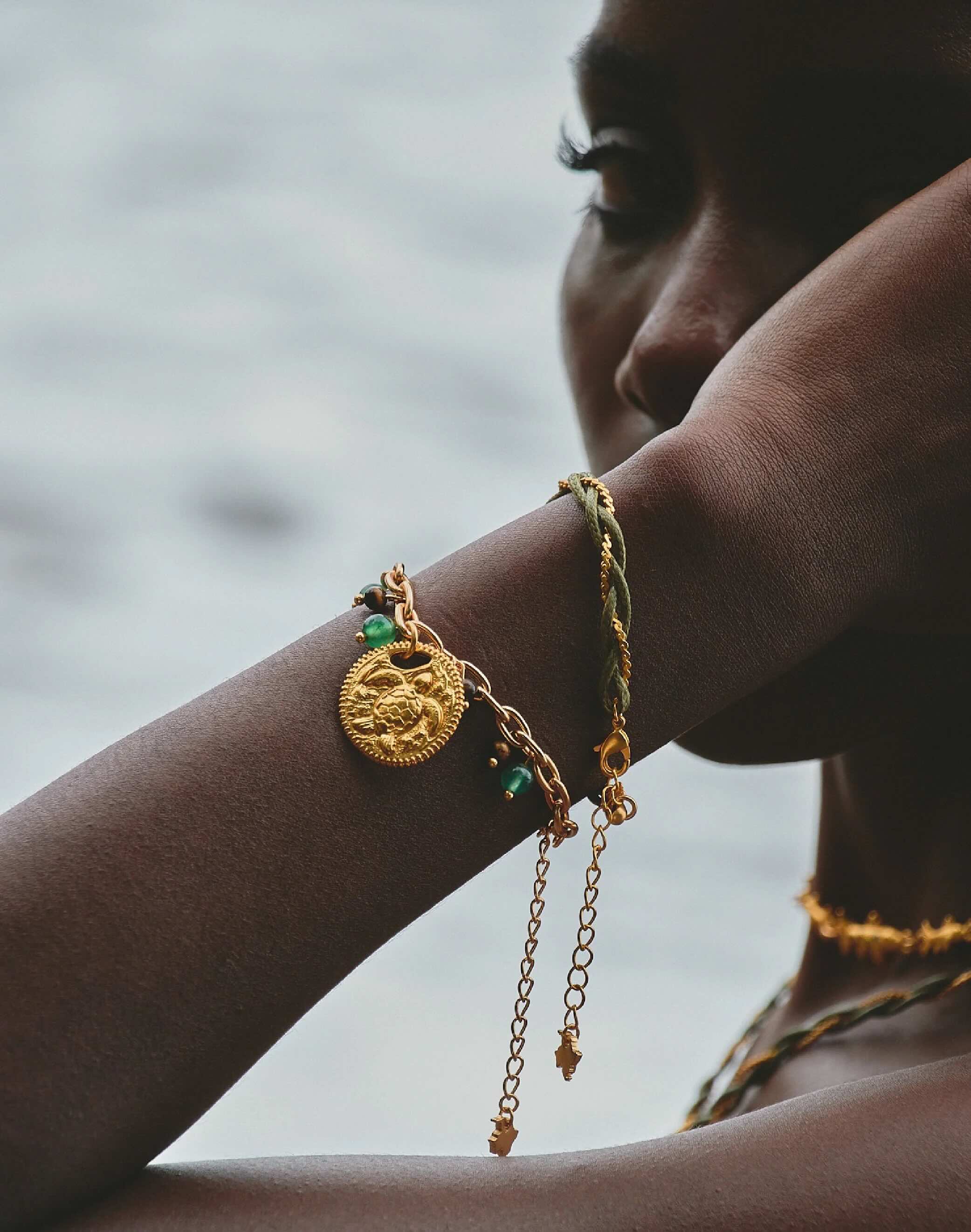 Woman wearing Refugio de Sol bracelet set with fossil jade and cat's eye stones.