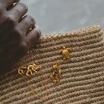 Close-up of a textured surface with gold animal-shaped pins.