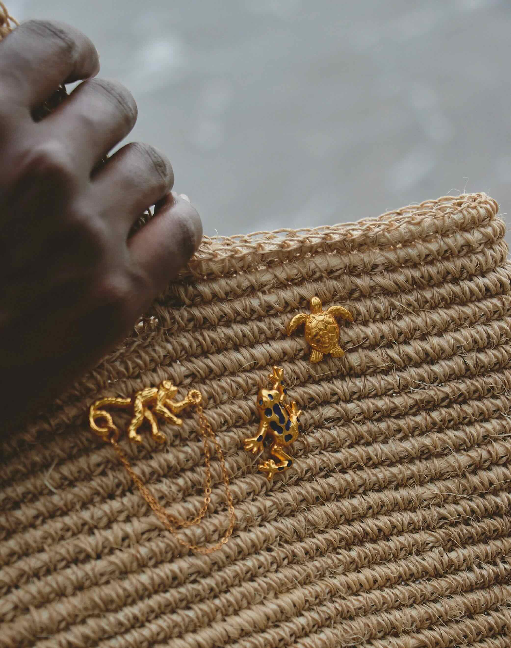Close-up of a textured surface with gold animal-shaped pins.
