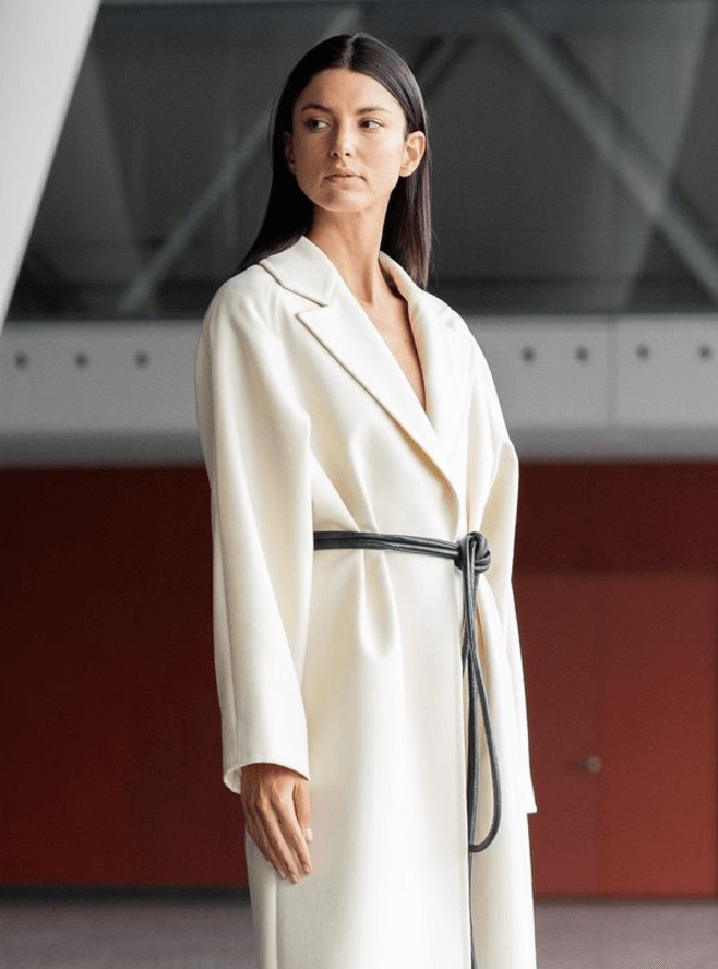 Lady wearing a coat and black tokyo belt