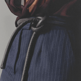 Lady wearing blouse, pants and black tokyo belt