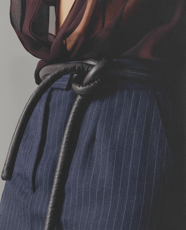 Lady wearing blouse, pants and black tokyo belt