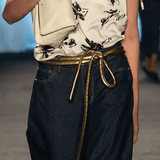 Lady wearing a coat and gold tokyo belt