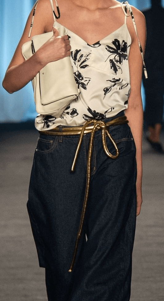 Lady wearing a coat and gold tokyo belt