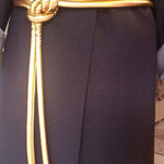 Lady wearing a coat and gold tokyo belt