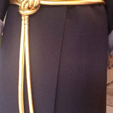 Lady wearing a coat and gold tokyo belt
