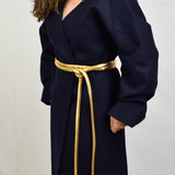 Lady wearing a coat and gold tokyo belt