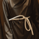 Lady wearing a coat and white tokyo belt