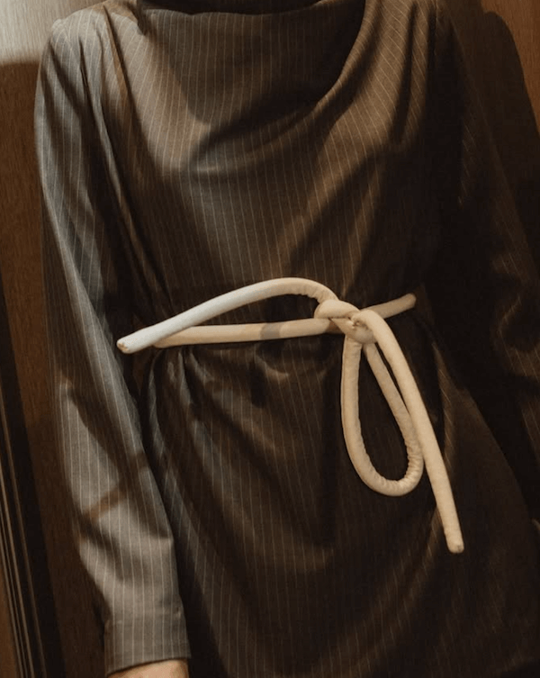 Lady wearing a coat and white tokyo belt