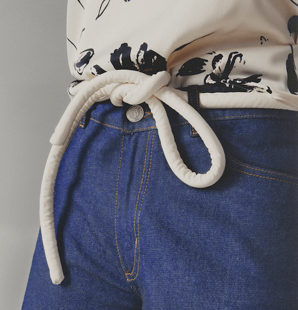 Lady wearing a coat and white tokyo belt