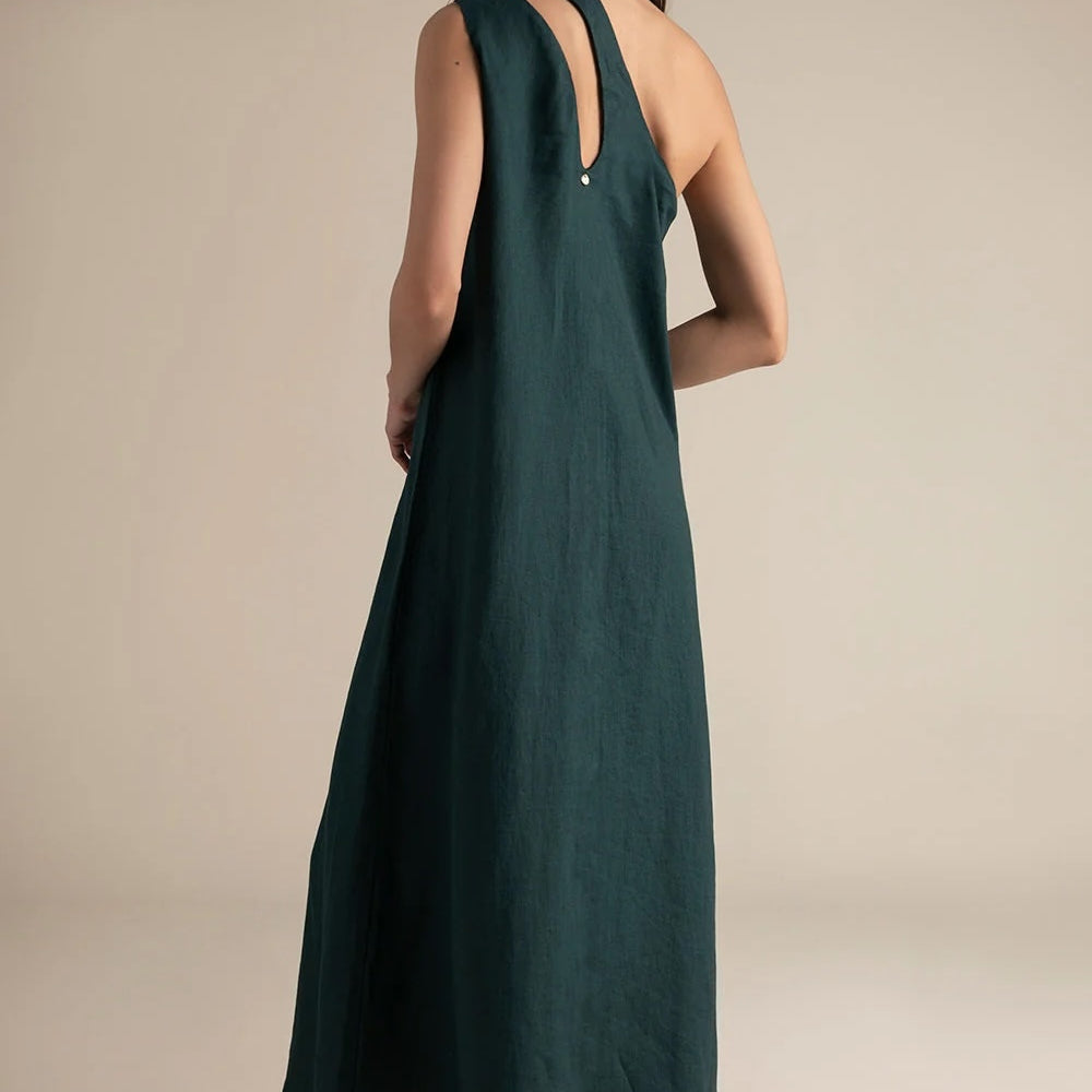 Woman wearing a green one-shoulder dress against a beige background.
