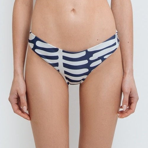 Close up of a model wearing a navy and white nautical stripe bikini bottom made from high-quality nylon and spandex.