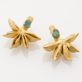 Image of two matching earrings with anise seeds and rough emerald studs. The purpose of this image is to highlight the earrings by Alma Jewelry. 
