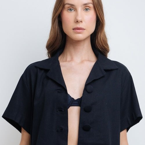 Woman wearing Claudette Navy Blue Crop Shirt by Mar de Lua with button-front detail. Made in Colombia, available at EVAMAIA Boutique, Studio City, Los Angeles, CA.