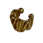 Close-up image of an earcuff in gold. It's set against a white background. The purpose of this image is to highlight the earcuff by Pajarolimon Jewelry.