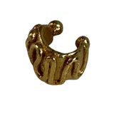 Close-up image of an earcuff in gold. It's set against a white background. The purpose of this image is to highlight the earcuff by Pajarolimon Jewelry.