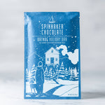 Spinnaker Chocolate Oatdog Holiday Bar packaging with winter scene illustration on a white background.