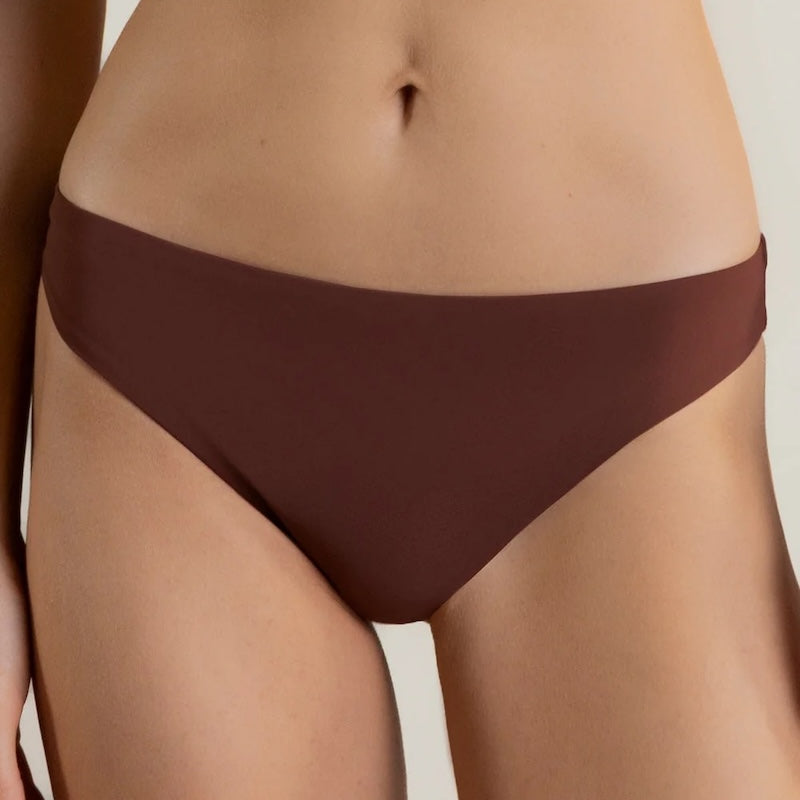 Brown bikini bottom worn by a person on a white background.