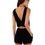 Image of a woman wearing a romper with a cutout in the back. This is the Black Halo Romper by Malai Swimwear. The purpose of the image is to highlight the romper.