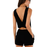 Image of a woman wearing a romper with a cutout in the back. This is the Black Halo Romper by Malai Swimwear. The purpose of the image is to highlight the romper.