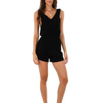 Image of a woman wearing a romper. This is the Black Halo Romper by Malai Swimwear. The purpose of the image is to highlight the romper.