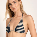 Close-up image of a model wearing a bikini with blue and white stripes. She's against a white background. The purpose of this image is to show the bikini.