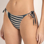 Close-up image of a woman wearing a bikini bottom with blue and white stripes. She's against a white background. The purpose of this image is to show the bikini.