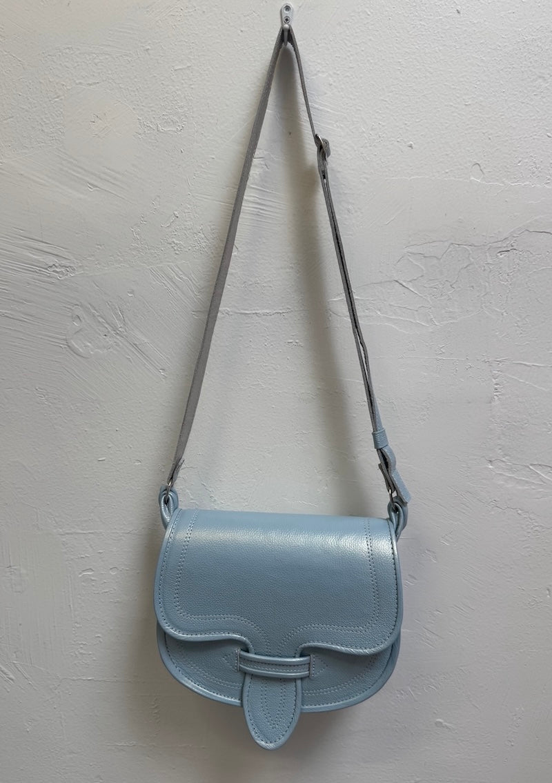 Light blue handbag with a strap on a light gray background