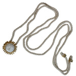 image of a cord necklace with a sun charm. it's against a white background. the purpose of this image is to highlight the necklace by Pajarolimon jewelry because it's for sale at EVAMAIA Boutique in Studio City, CA.