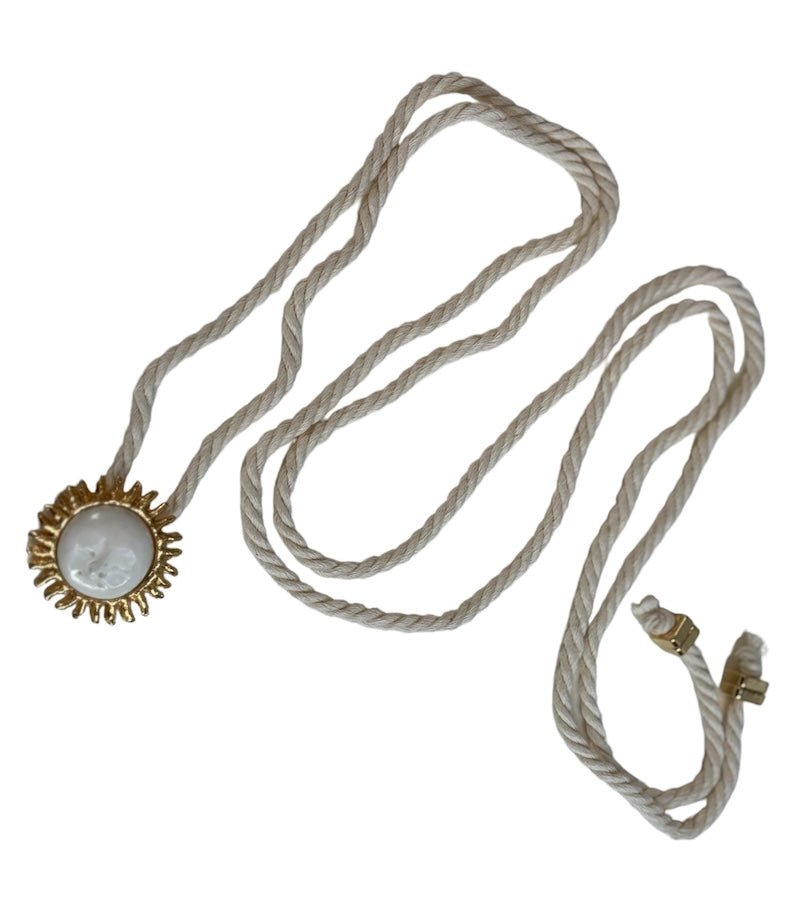 image of a cord necklace with a sun charm. it's against a white background. the purpose of this image is to highlight the necklace by Pajarolimon jewelry because it's for sale at EVAMAIA Boutique in Studio City, CA.