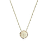 image of a cord necklace with a sun charm. it's against a white background. the purpose of this image is to highlight the necklace by Pajarolimon jewelry because it's for sale at EVAMAIA Boutique in Studio City, CA.